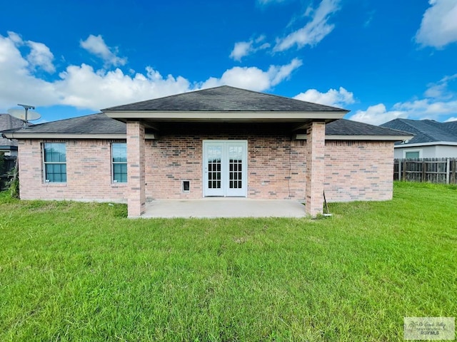 back of house with a lawn and a patio area