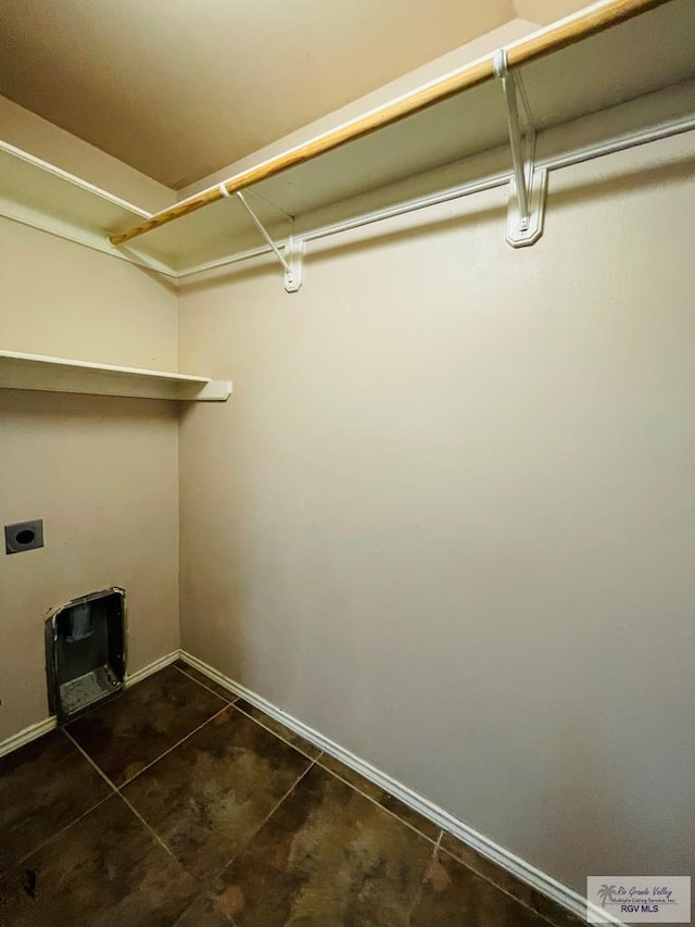 washroom featuring electric dryer hookup and heating unit