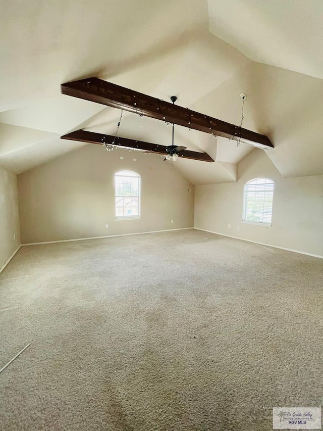 bonus room featuring lofted ceiling with beams and a healthy amount of sunlight