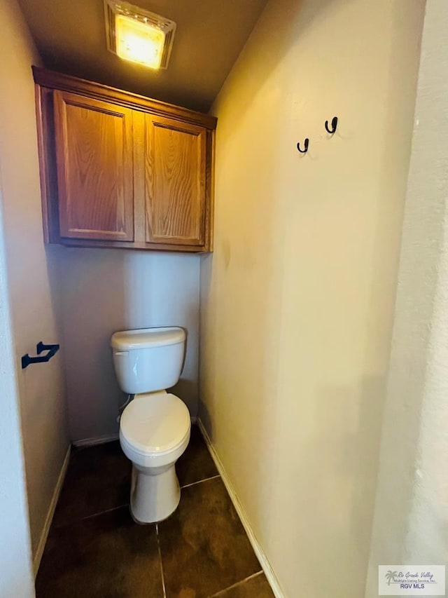 bathroom with tile patterned flooring and toilet