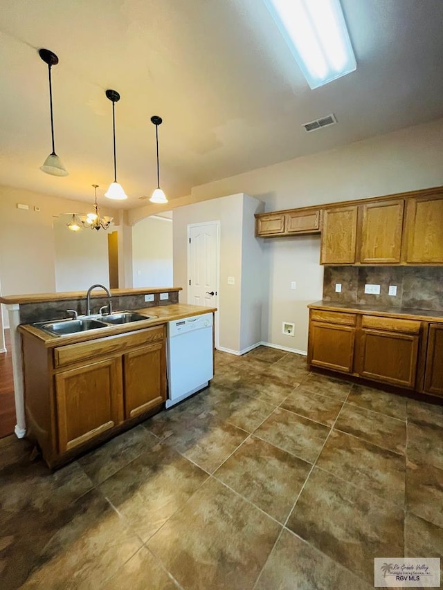 kitchen with dishwasher, sink, decorative light fixtures, tasteful backsplash, and a notable chandelier