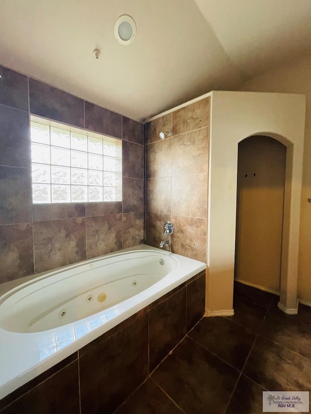 bathroom featuring tiled shower / bath combo and tile patterned floors