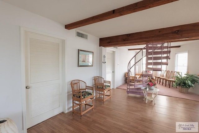 109 E Pompano St, South Padre Island, TX 78597 - living area with beam ceiling, stairway, and wood finished floors