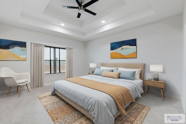 bedroom with a raised ceiling and ceiling fan