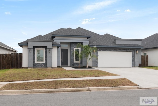 prairie-style house with a garage and a front lawn