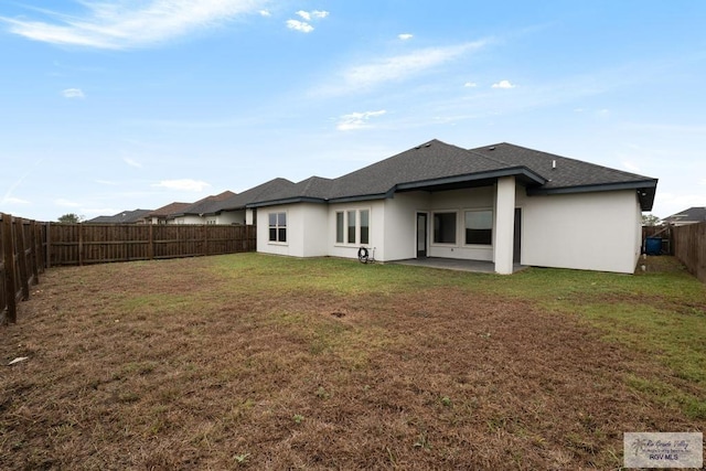 back of house featuring a yard and a patio