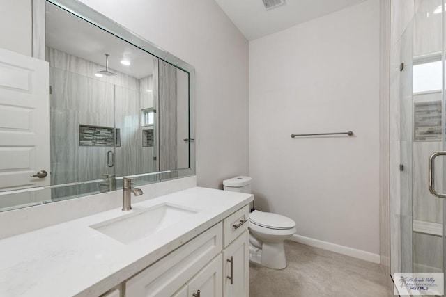 bathroom featuring vanity, toilet, and a shower with door