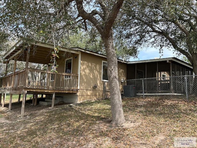 rear view of property with a sunroom