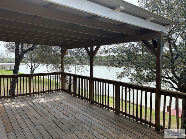 wooden terrace featuring a water view