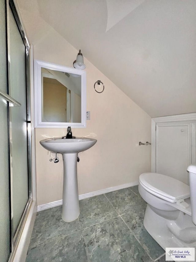 144 Country Club Rd Unit 1, Brownsville, TX 78520 - bathroom with toilet, baseboards, lofted ceiling, and a shower with door