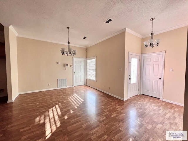144 Country Club Rd Unit 1, Brownsville, TX 78520 - foyer featuring a textured ceiling, a notable chandelier, and visible vents