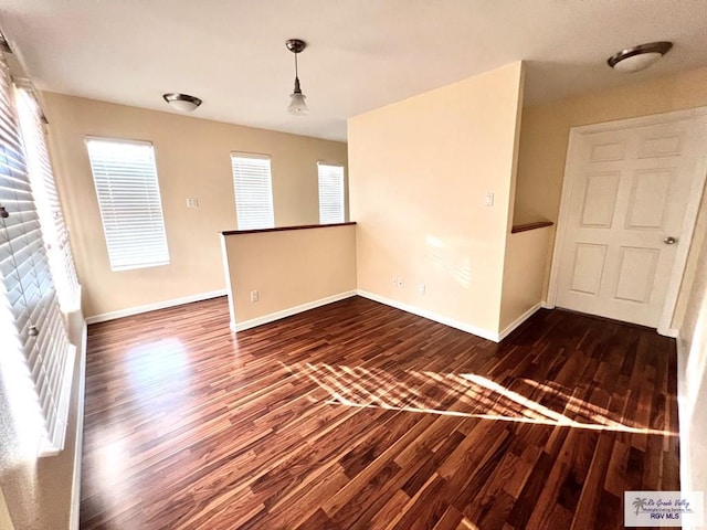 144 Country Club Rd Unit 1, Brownsville, TX 78520 - unfurnished room with dark wood-style floors, baseboards, and a healthy amount of sunlight