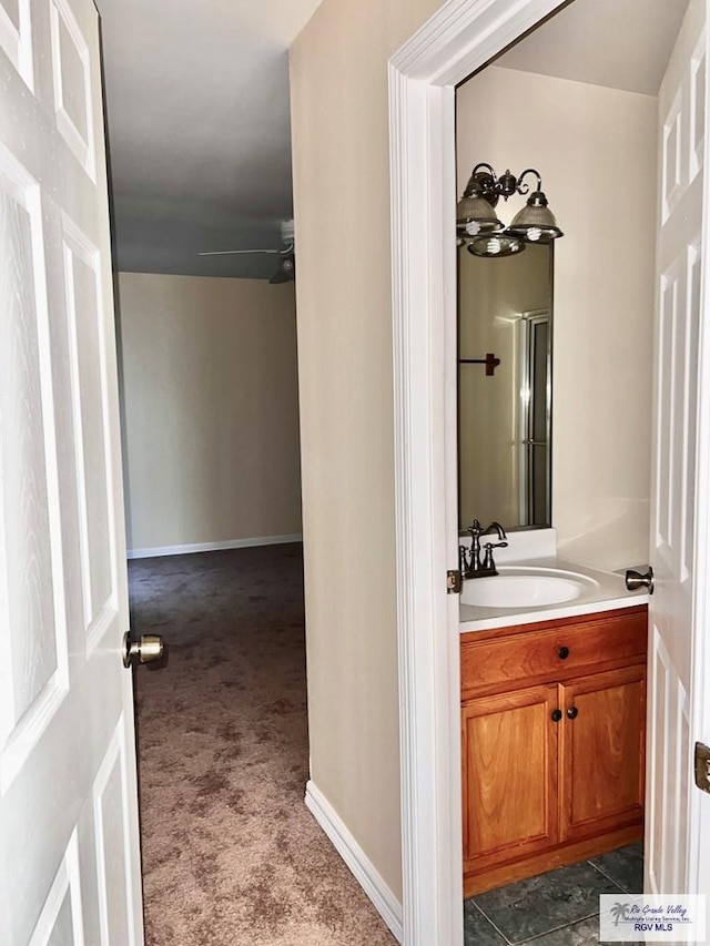 144 Country Club Rd Unit 1, Brownsville, TX 78520 - bathroom featuring baseboards, ceiling fan, and vanity