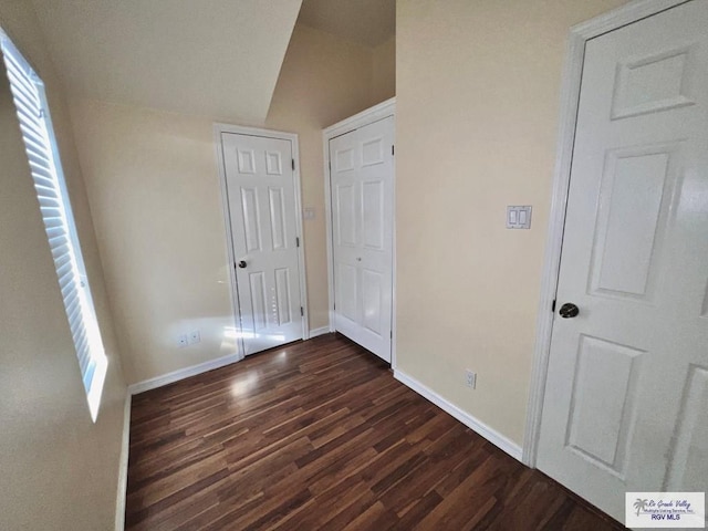 144 Country Club Rd Unit 1, Brownsville, TX 78520 - unfurnished bedroom with baseboards, vaulted ceiling, and dark wood-style floors