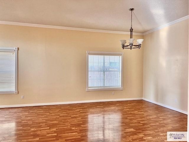 144 Country Club Rd Unit 1, Brownsville, TX 78520 - unfurnished room featuring a notable chandelier, baseboards, ornamental molding, and wood finished floors