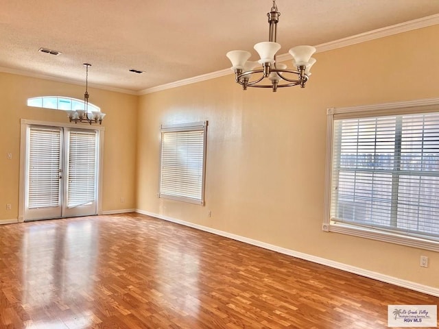 144 Country Club Rd Unit 1, Brownsville, TX 78520 - spare room with a chandelier, baseboards, crown molding, and wood finished floors