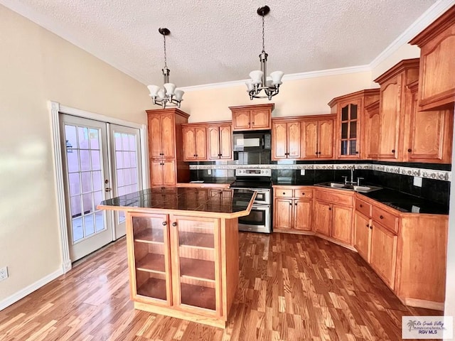 144 Country Club Rd Unit 1, Brownsville, TX 78520 - kitchen with black microwave, a textured ceiling, a chandelier, a sink, and range with two ovens