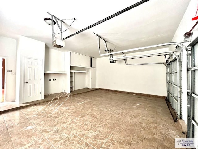 144 Country Club Rd Unit 1, Brownsville, TX 78520 - garage featuring baseboards and a garage door opener