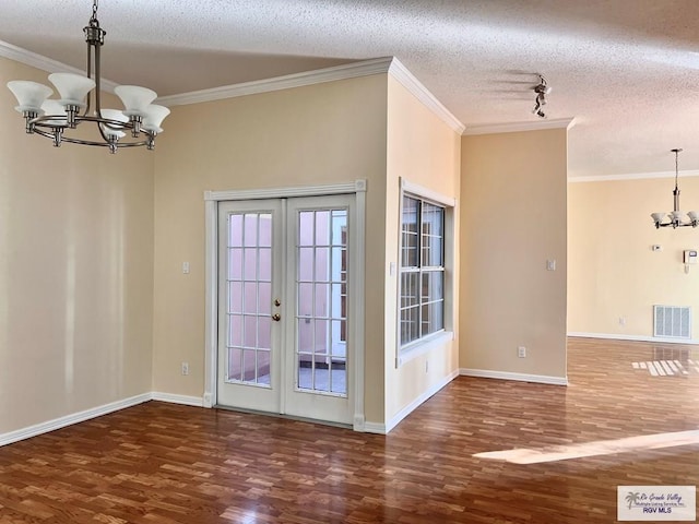 144 Country Club Rd Unit 1, Brownsville, TX 78520 - doorway to outside with french doors, visible vents, a notable chandelier, and wood finished floors