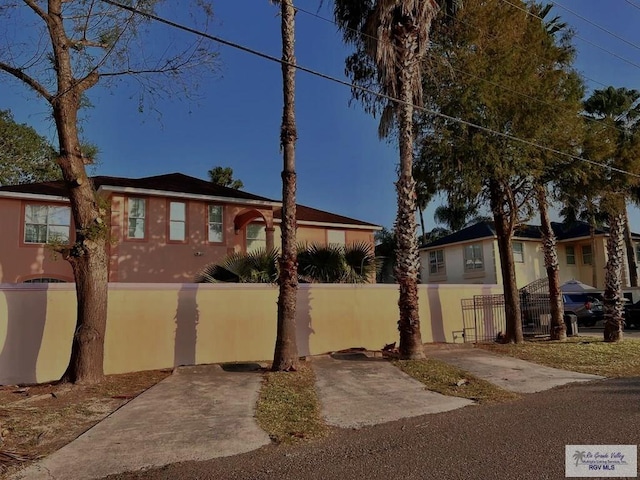 144 Country Club Rd Unit 1, Brownsville, TX 78520 - view of front of home with a fenced front yard and stucco siding