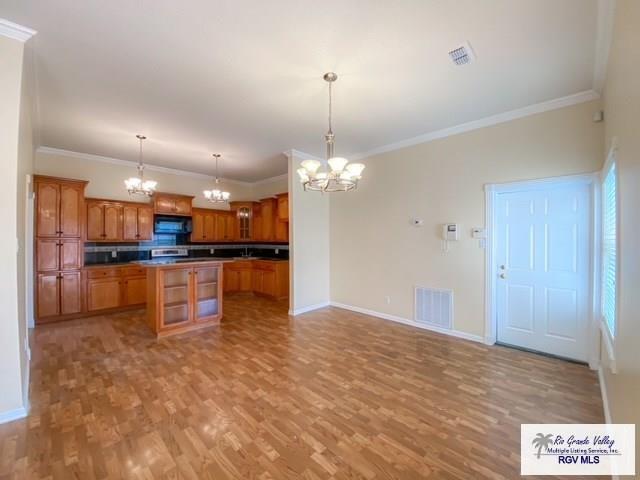 144 Country Club Rd Unit 1, Brownsville, TX 78520 - kitchen with visible vents, an inviting chandelier, and light wood-style floors
