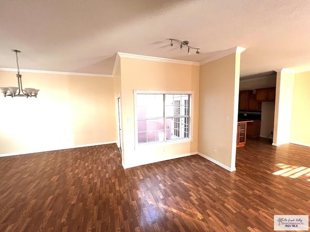 144 Country Club Rd Unit 1, Brownsville, TX 78520 - unfurnished living room featuring crown molding, baseboards, and an inviting chandelier