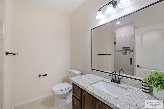 full bath with vanity, toilet, a stall shower, baseboards, and tile patterned flooring