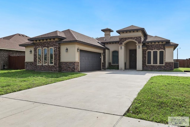 mediterranean / spanish-style home featuring stucco siding, fence, a front lawn, concrete driveway, and an attached garage