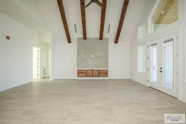 unfurnished living room featuring french doors, high vaulted ceiling, and beamed ceiling