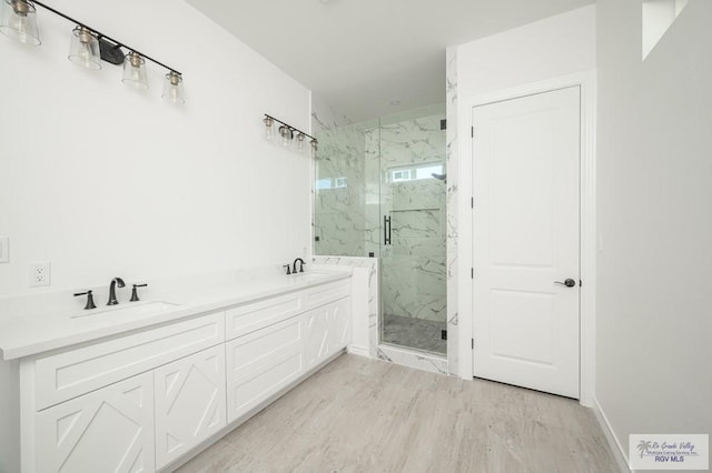 bathroom featuring hardwood / wood-style floors, vanity, and a shower with door