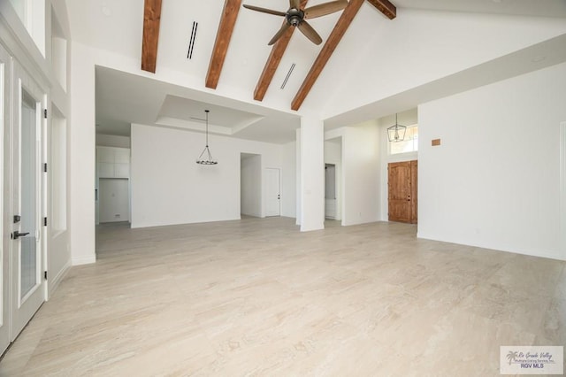 unfurnished living room featuring beamed ceiling, ceiling fan with notable chandelier, high vaulted ceiling, and light hardwood / wood-style flooring