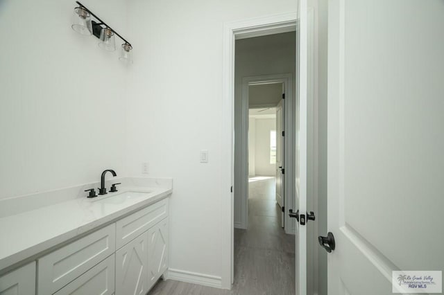 bathroom featuring a bathing tub, vanity, and hardwood / wood-style flooring