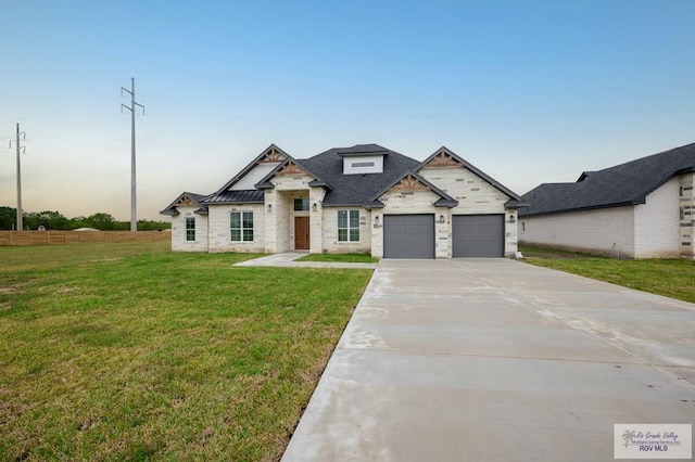 view of front of property with a yard and a garage