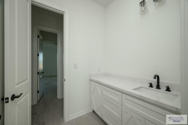 bathroom with vanity and hardwood / wood-style flooring