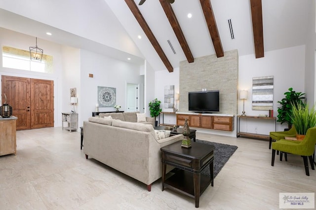 living room featuring beamed ceiling and high vaulted ceiling