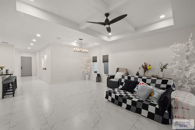 interior space featuring ceiling fan with notable chandelier, beam ceiling, and a tray ceiling