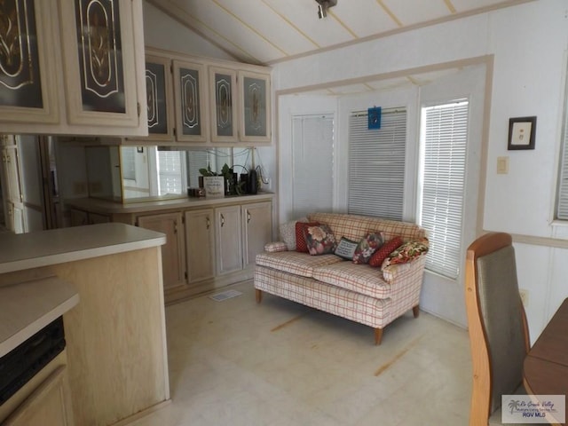 interior space with light colored carpet and lofted ceiling