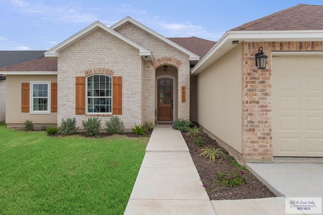 view of front of property with a garage, a front yard, brick siding, and a shingled roof