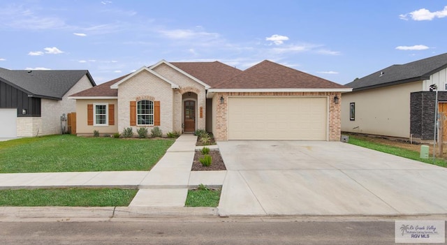 single story home featuring brick siding, an attached garage, driveway, and a front lawn