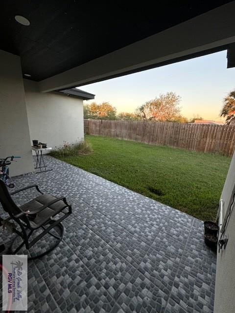 patio terrace at dusk with a lawn