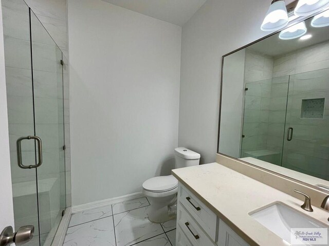 bathroom featuring vanity, an enclosed shower, and toilet