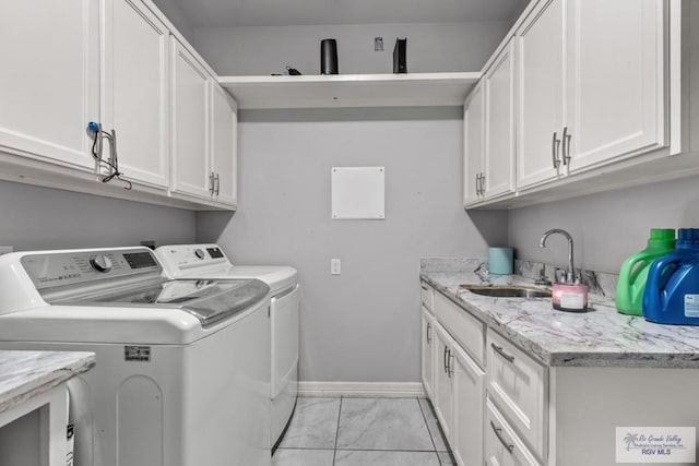34164 Quail Dr, San Benito, TX 78586 - laundry area with washing machine and dryer, cabinet space, light marble finish floors, and baseboards