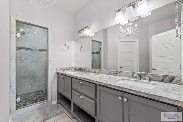 34164 Quail Dr, San Benito, TX 78586 - bathroom featuring a stall shower, double vanity, and tile patterned flooring