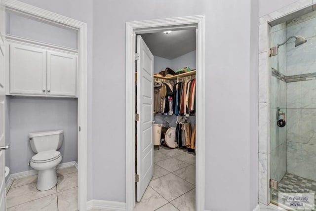 34164 Quail Dr, San Benito, TX 78586 - full bath with a stall shower, toilet, a walk in closet, tile patterned flooring, and baseboards