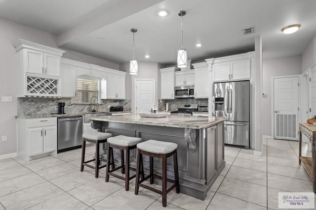34164 Quail Dr, San Benito, TX 78586 - kitchen with appliances with stainless steel finishes, a sink, tasteful backsplash, white cabinetry, and recessed lighting