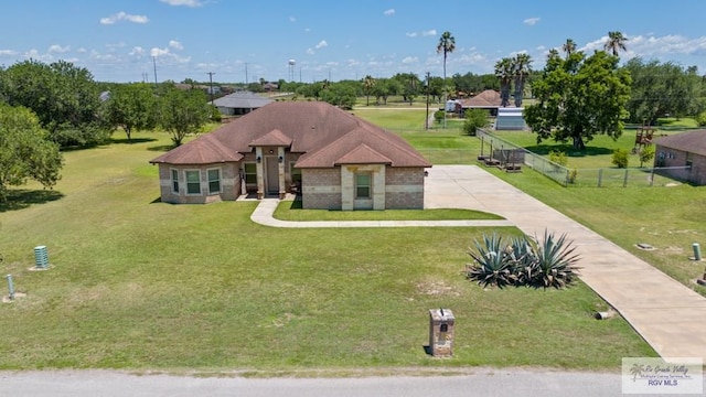 34164 Quail Dr, San Benito, TX 78586 - view of front of home featuring concrete driveway and view of wooded area