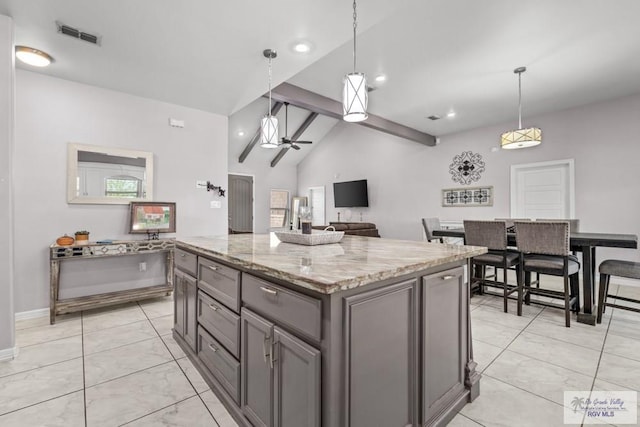 34164 Quail Dr, San Benito, TX 78586 - kitchen with gray cabinets, light stone countertops, ceiling fan, hanging light fixtures, and recessed lighting