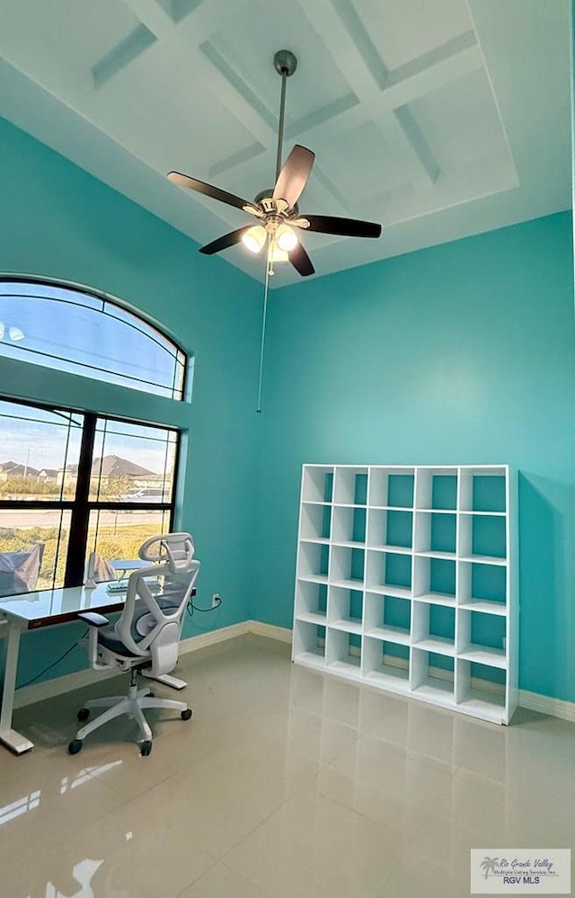 unfurnished office with tile patterned flooring, coffered ceiling, and ceiling fan