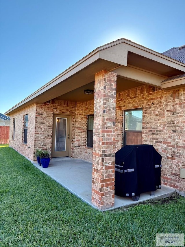 rear view of house with a yard and a patio area