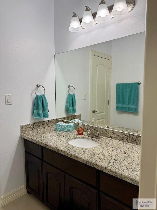 bathroom featuring vanity and baseboards